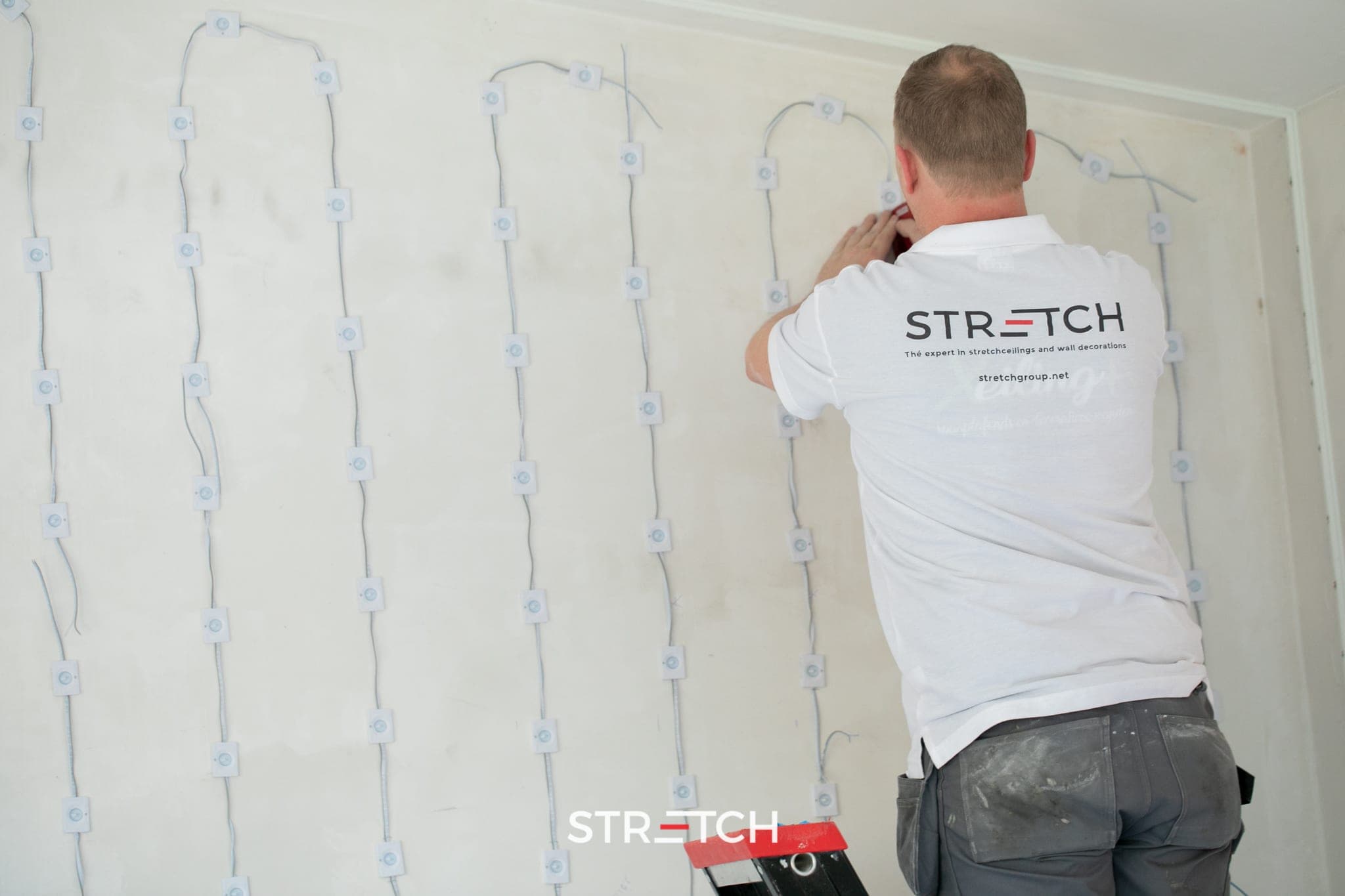 Certified STRETCH installer fitting a stretch ceiling
